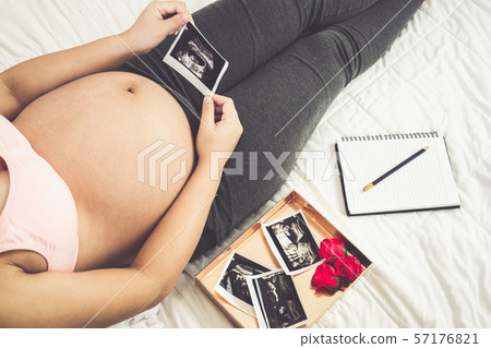 Happy pregnant woman and expecting baby at home. Happy pregnant woman and expecting baby at home. 57176821
