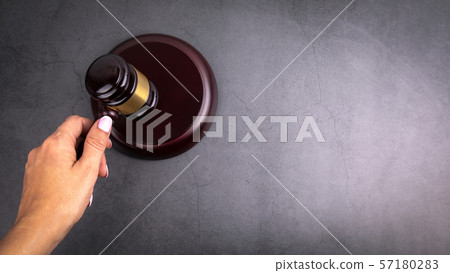 Judge hammer in hand of woman. Free space for text, copy space Judge hammer in hand of woman. Free space for text, copy space 57180283