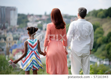 Family standing and enjoying amazing city view while walking 57181943