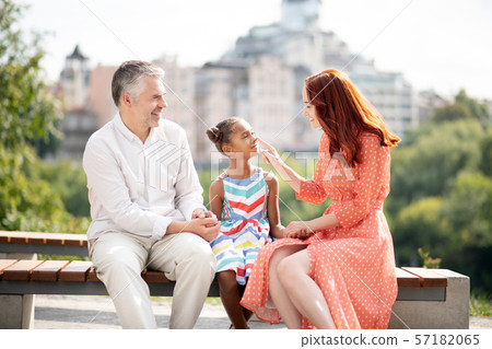 Loving red-haired foster mom touching nose of her cute girl 57182065