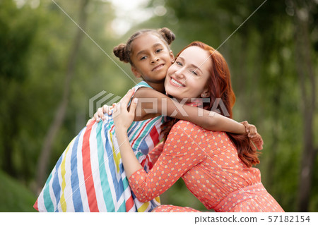 Loving caring mother hugging her cute appealing daughter 57182154