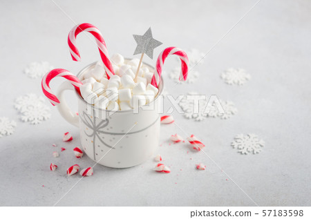New Year or Christmas concept. Composition with marshmallows and candy canes on a gray concrete background.  57183598