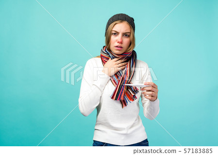 Sad teen girl having flue taking thermometer Sad teen girl having flue taking thermometer 57183885