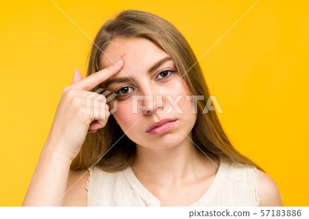 Portrait of sad teen gerl touching her face and Portrait of sad teen gerl touching her face and 57183886