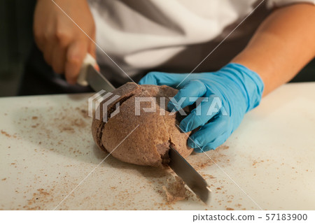 Blurry background of the chef is cutting the bread 57183900