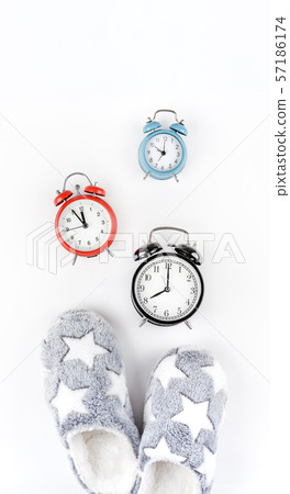 Soft fluffy slippers and alarm clocks 57186174