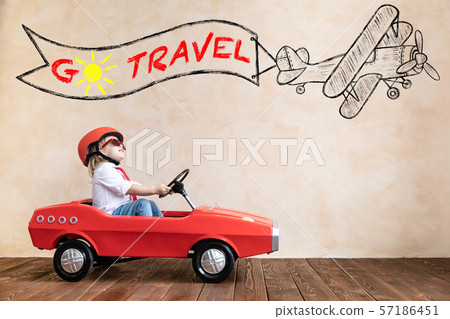 Funny kid driving toy car at home 57186451