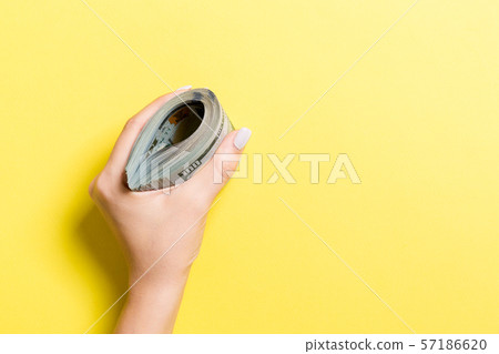 A thick pack of one hundred dollar bills in female A thick pack of one hundred dollar bills in female 57186620