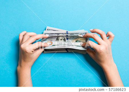 Top view of female hands counting money. One Top view of female hands counting money. One 57186623