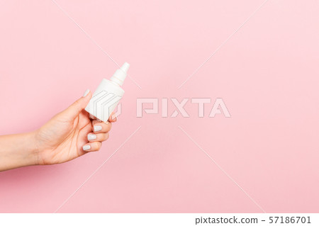 Female hand holding cream bottle of lotion Female hand holding cream bottle of lotion 57186701