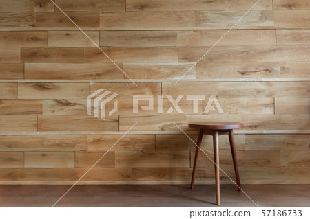 Round chair beside wooden wall 57186733
