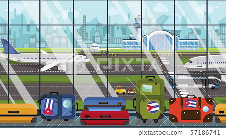 Suitcases with Cuban flag stickers on baggage carousel in airport. Tourism in Cuba conceptual Suitcases with Cuban flag stickers on baggage carousel in airport. Tourism in Cuba conceptual 57186741