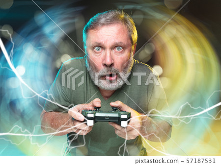 Enthusiastic gamer. Joyful man holding a video game controller 57187531