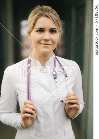 Close-up portrait of young caucasian doctor woman with stethoscope 57188556