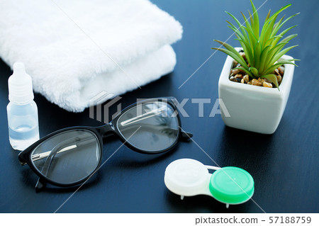 Glasses and objects for cleaning and storing contact lenses, to improve vision, on a black Glasses and objects for cleaning and storing contact lenses, to improve vision, on a black 57188759