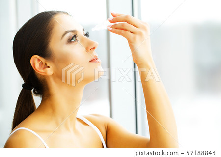 Young Beautiful Woman With Eyedrops. Vision And Medicine Concept Young Beautiful Woman With Eyedrops. Vision And Medicine Concept 57188843
