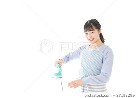 Young housewife ironing 57192299