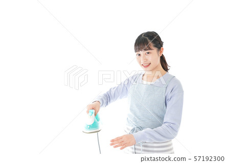 Young housewife ironing 57192300