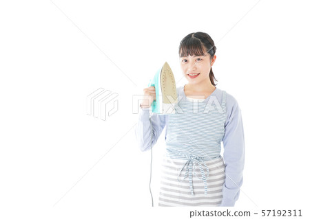 Young housewife ironing 57192311