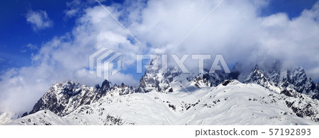 Snow mountains in fog at sun winter day Snow mountains in fog at sun winter day 57192893