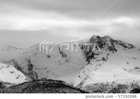 Snowy mountains and gray overcast sky before snow Snowy mountains and gray overcast sky before snow 57192896