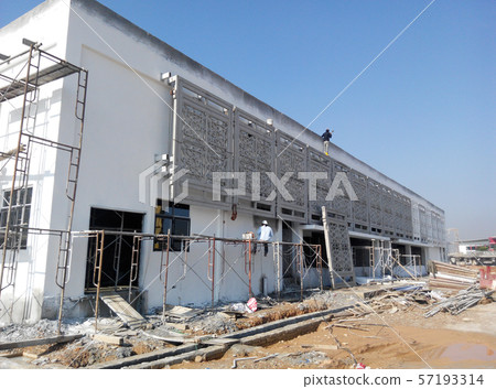 GRC (Glass Fibre Reinforce Concrete) with Islamic geometry pattern installation work at the construction site by the construction workers.  57193314