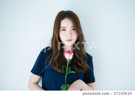 Young woman with a single rose Young woman with a single rose 57193614