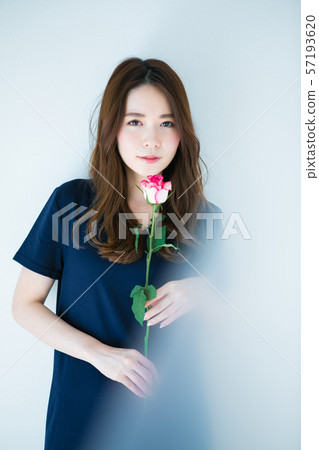 Young woman with a single rose 57193620