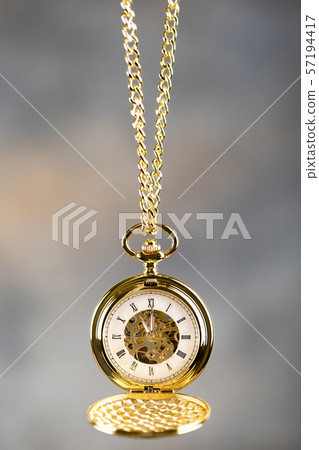 Vintage pocket watch hanging on a chain. Roman Vintage pocket watch hanging on a chain. Roman 57194417