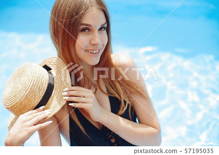 Girl on summer party in the swimming pool Girl on summer party in the swimming pool 57195035