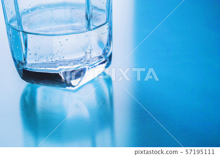 Glass cup with a little carbonated water Glass cup with a little carbonated water 57195111
