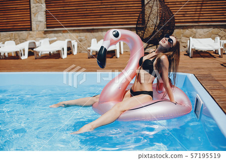 Girl on summer party in the swimming pool 57195519