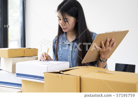 Online small business owner checking order. Online small business owner checking order. 57195759