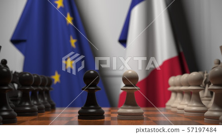 Flags of the EU and France behind chess board. The first pawn moves in the beginning of the game 57197484