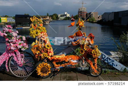 Bicycle decorated with flowers on a dutch bridge in amsterdam Bicycle decorated with flowers on a dutch bridge in amsterdam 57198214
