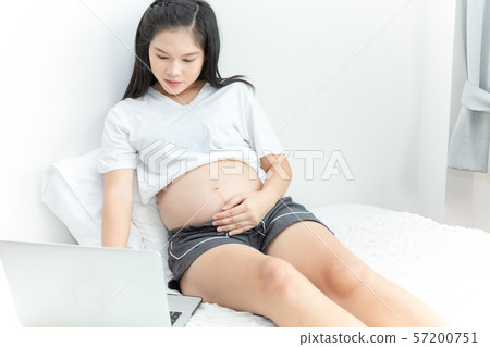 portrait of an asian pregnant woman using laptop portrait of an asian pregnant woman using laptop 57200751