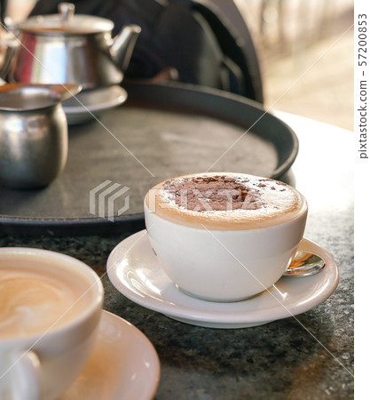 Cup of cappucino on table in a cafe 57200853