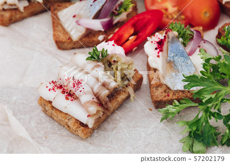 Delicious canapes with herring.Macro of delicious 57202179
