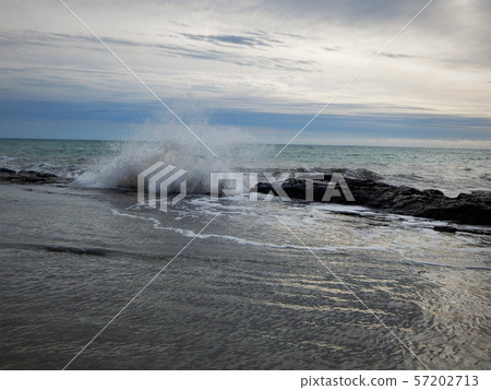 Wave breaks on the rocks. Wave breaks on the rocks. 57202713