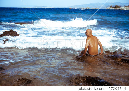 handsome man on the marine rocky shore handsome man on the marine rocky shore 57204244