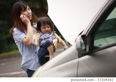 Mother and girl with broken car Mother and girl with broken car 57204591