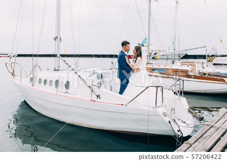 Wedding couple on the yacht, lovers posing on the 57206422