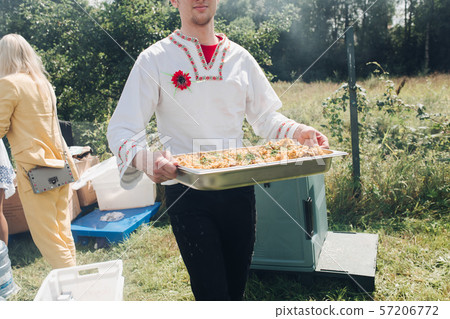 Man with a big container of pilaf. Man with a big container of pilaf. 57206772