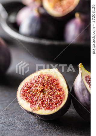 A few figs in a black bowl on an dark concrete A few figs in a black bowl on an dark concrete 57208126
