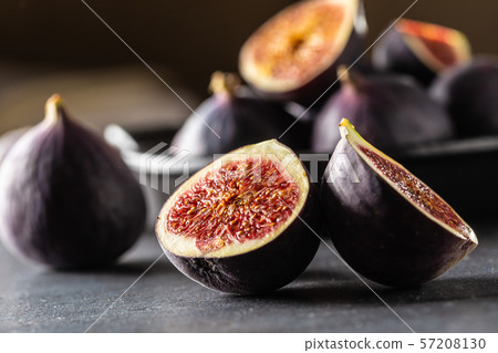 A few figs in a black bowl on an dark concrete A few figs in a black bowl on an dark concrete 57208130