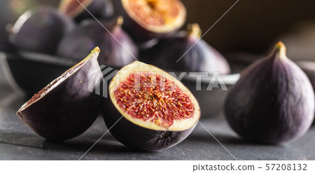 A few figs in a black bowl on an dark concrete A few figs in a black bowl on an dark concrete 57208132