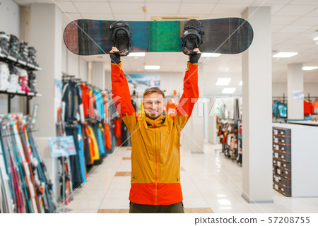 Man raised up the board for snowboarding, shopping Man raised up the board for snowboarding, shopping 57208755