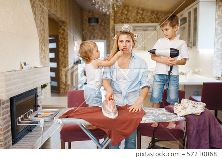 Housewife and kids playing with hair dryer 57210068