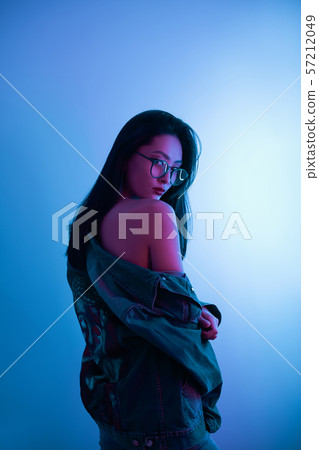 Studio Portrait of Asian Woman Over Urban Neon Lights. 57212049
