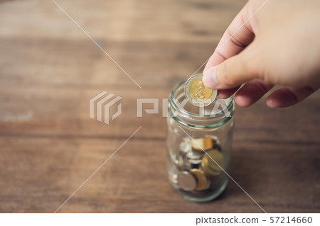 Business men Put the coin in a glass jar To save Business men Put the coin in a glass jar To save 57214660